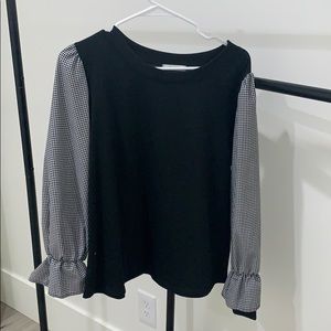 black sweater with checkered sleeves